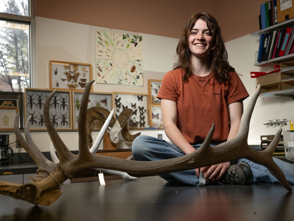 A picture of Jocelyn Stansberry with an elk antler at UM.