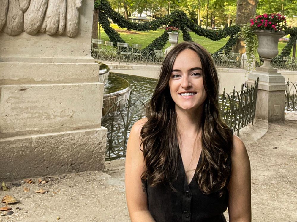 A picture of Tristyn Page in a French garden park.