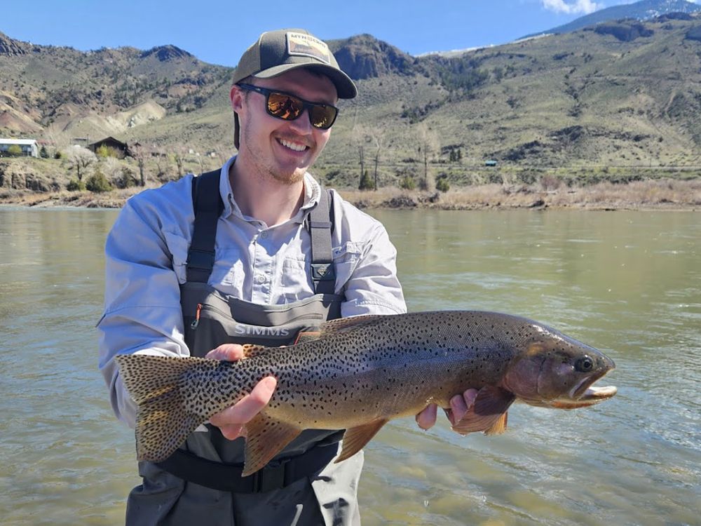 Colter Feuerstein holds a trout in the Yellowstone River.