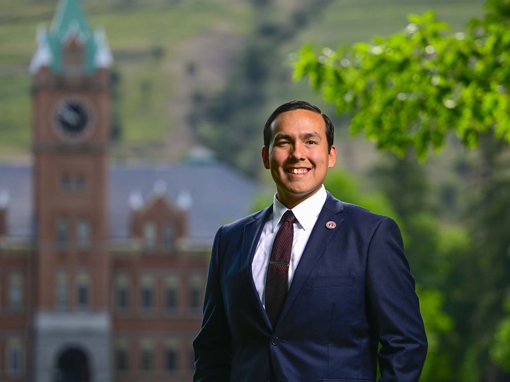 A picture of LaRenzo Roanbear before Main Hall on the UM campus.