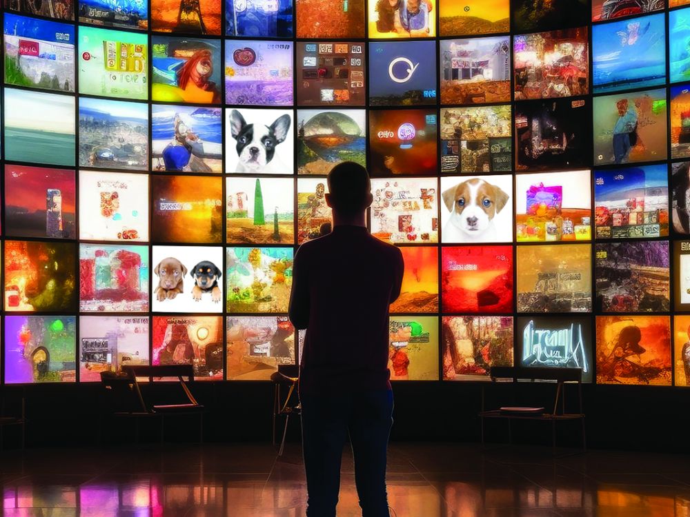 A man looking at a bunch of screens. Some screens show puppies.