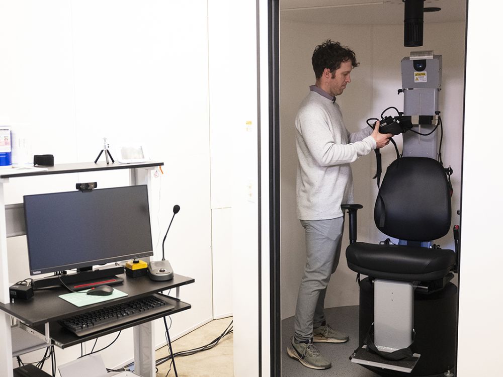 Researcher Brian Loyd works with a spinning research chair in his UM lab.