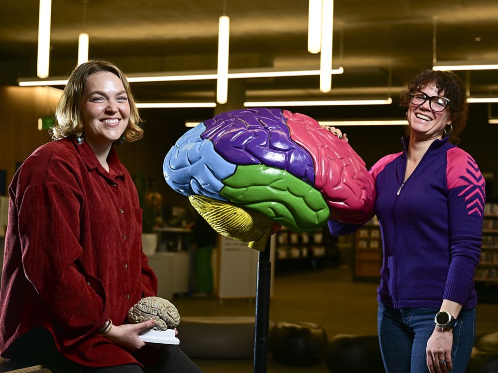 Halle Townes (left) and Alex Sobin pose with a large plastic brain.