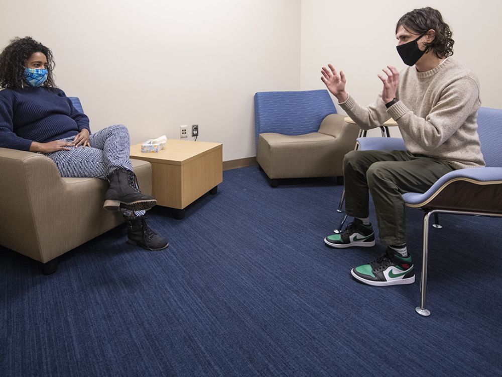 Two UM doctoral students sit and talk in one of UM's counseling rooms in the College of Education Building. 
