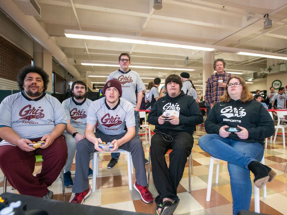 UM students playing video games with Griz shirts on.