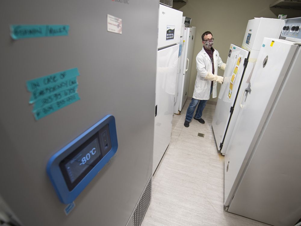 Kenneth Chatriand, pharmacist pharmacy manager, opens a subzero freezer. 