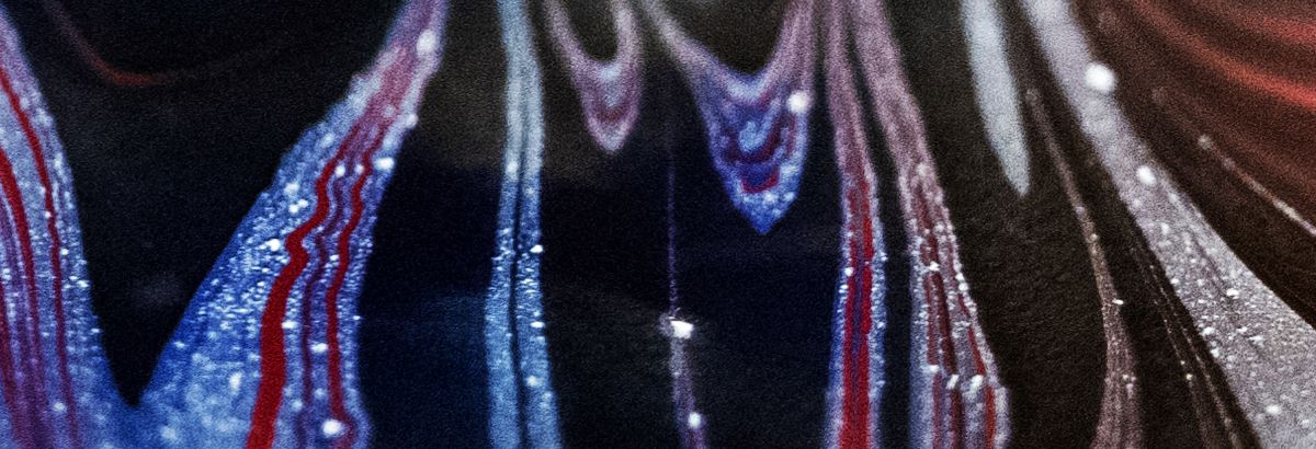 closeup view of streaks of red, white, maroon and black colors