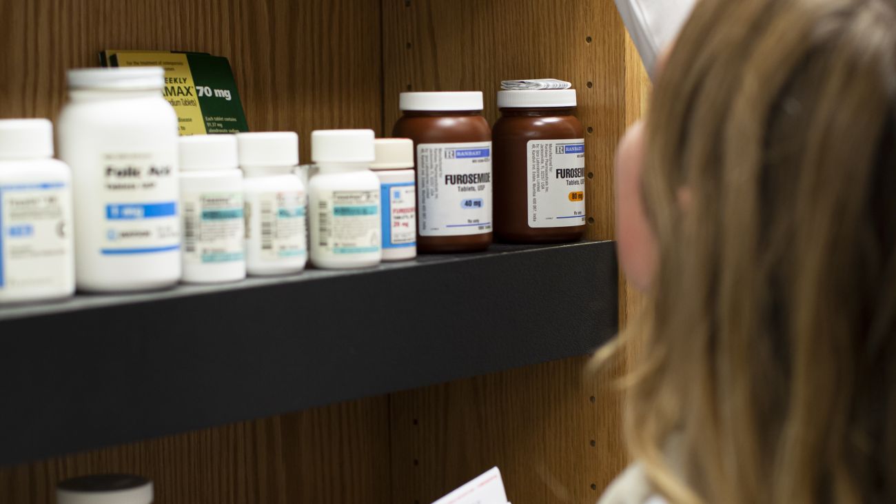 woman reaching for medication 