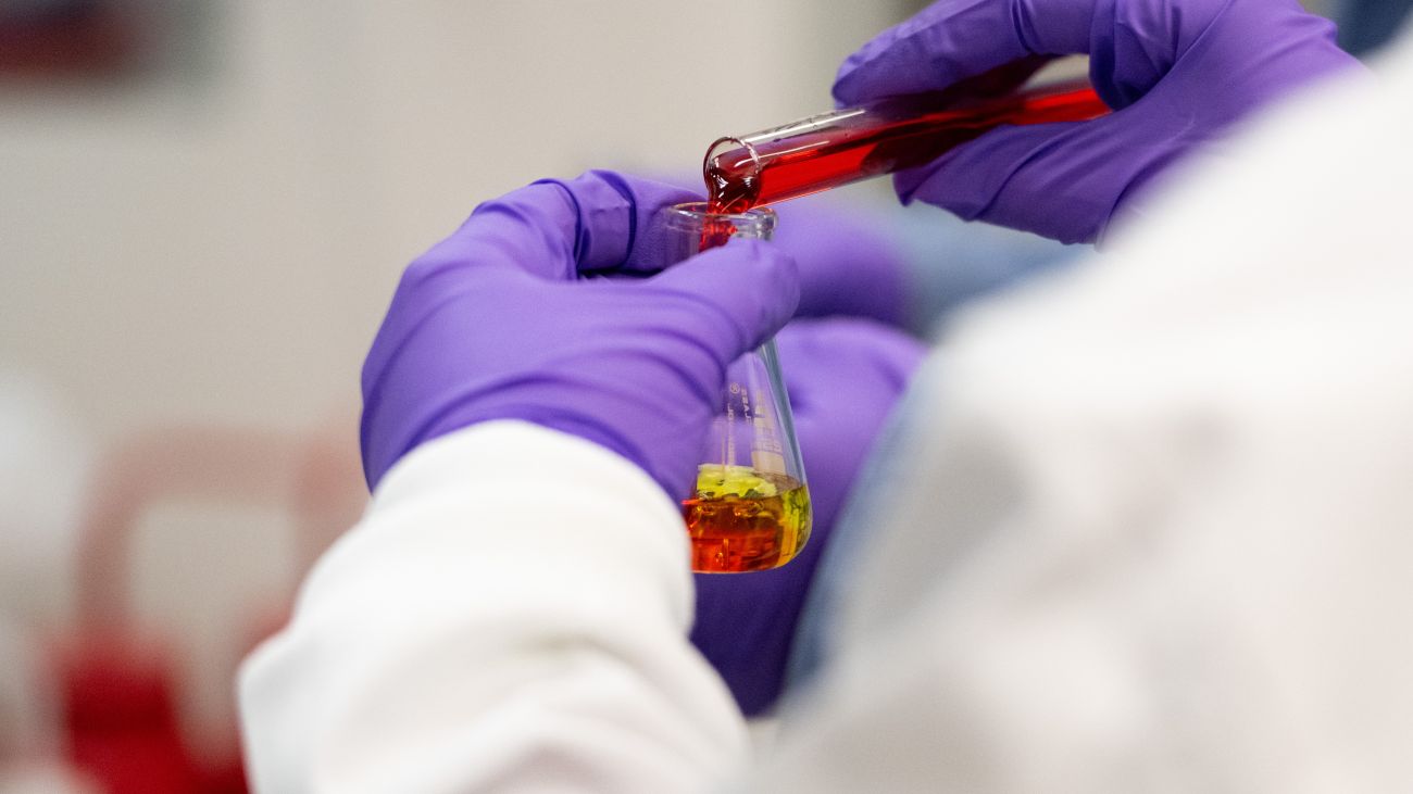 red liquid being poured into a beaker