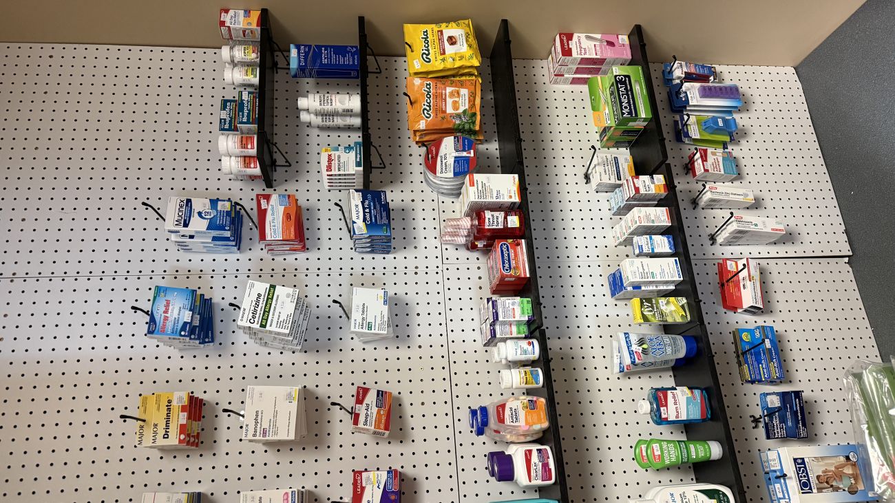 Display stocked with a variety of over-the-counter medications available for purchase at the Health Services Pharmacy.