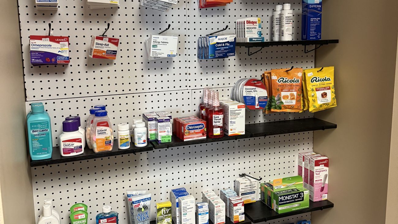 Display stocked with a variety of over-the-counter medications available for purchase at the Health Services Pharmacy.