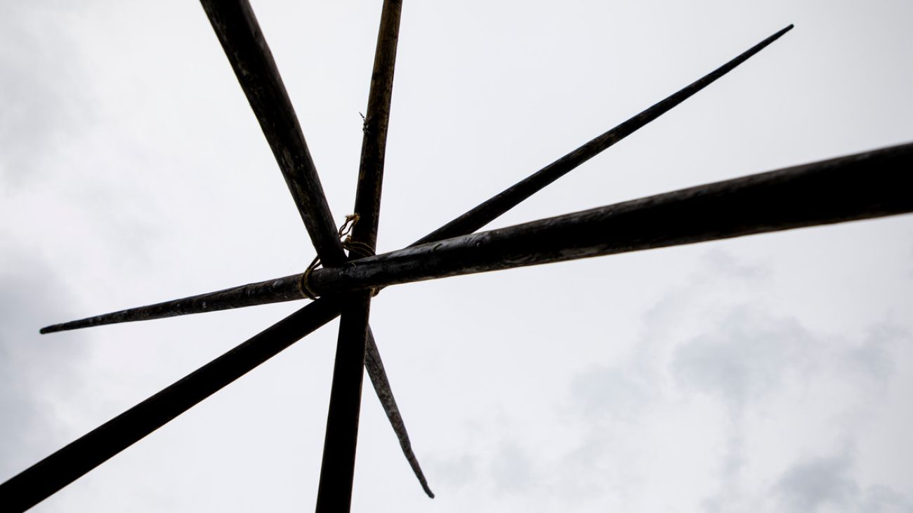 picture narrow wooden beans crossing over each other and tied together