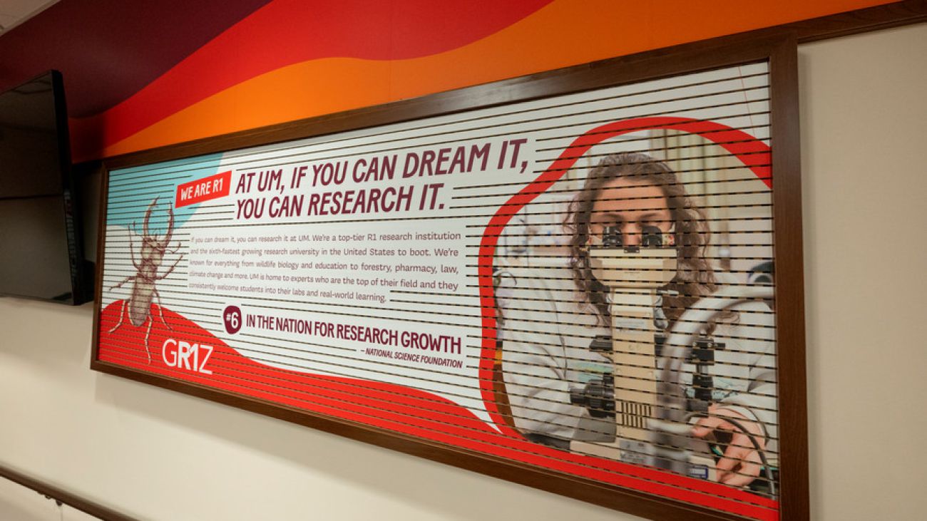 image of a metal poster of a beetle telling people to be curious