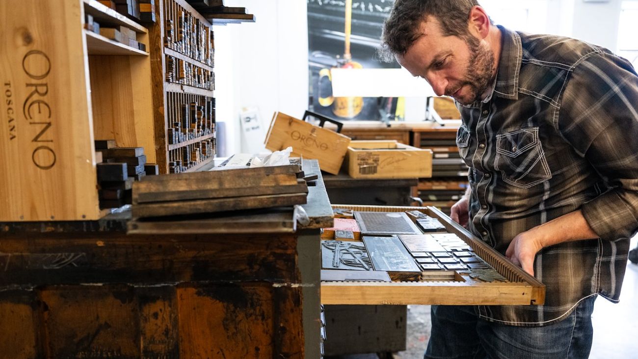 Student looking at letter press blocks