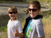Two boys wearing sunglasses and smiling