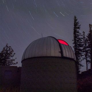 blue montian observatory with stary sky in background