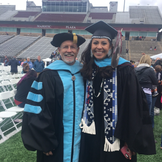 faculty with student on graduation