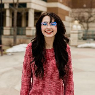 Image of Talia smiling ready to help you make Missoula your next adventure