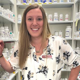 UM student Shelby Brooks poses for a photo in a pharmacy