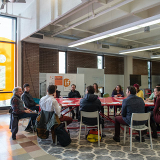 UM employees gather around a table for a professional development session