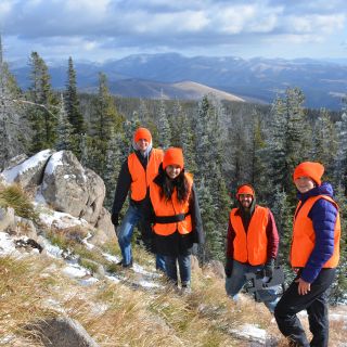 A group of students installs monitoring equipment in the mountains