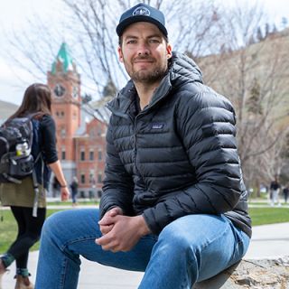 UM student veteran Kyle Brekke sits on the Oval