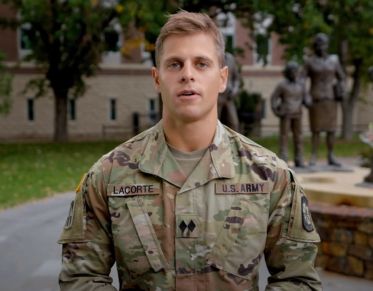 UM student Nate LaCorte looks at the camera and speaks while standing near the Fallen Soldier Memorial at UM.