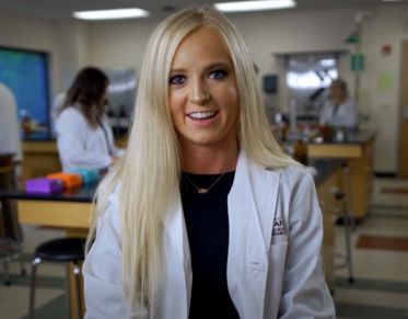 UM student Shea Dolan speaks to the camera while sitting in pharmacy classroom at UM.