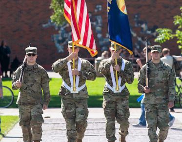 Members of UM's color guard present the flags on the Oval