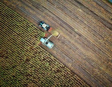 Top view of tractors farming from Unsplach.com by: No One Cares