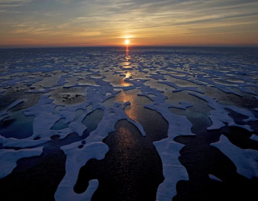 midnight sun shines across sea ice along the Northwest Passage in the Canadian Arctic Archipelago, on July 22, 2017. DAVID GOLDMAN/THE ASSOCIATED PRESS