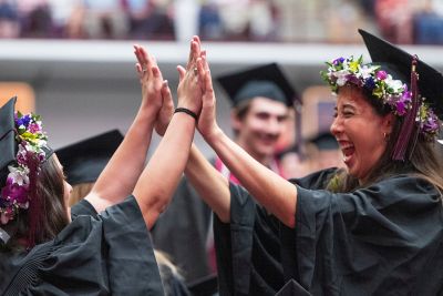 Two students celebrate at Commencement