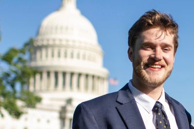 Nick Mills poses for a photo before the U.S Capitol building.