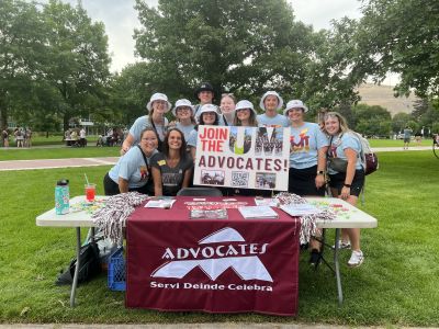 UM Advocates pose holding a "Join UM Advocates" sign 2023