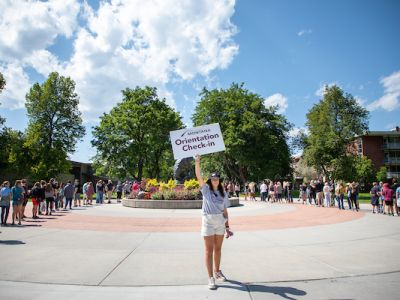 Jorgie poses with Orientation check in sign