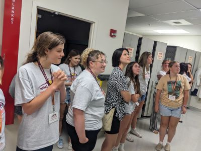 students look up at a display out of frame