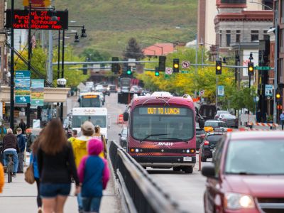 An ASUM Bus travels a busy street