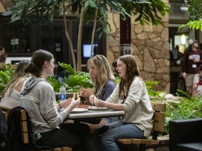 A group of students sit at a table in the University Center