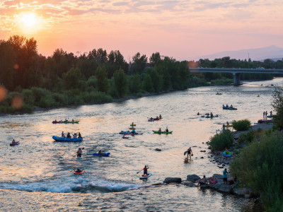 People floating the Clark Fork River at sunset