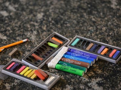 Colorful drawing tools on a marble countertop.