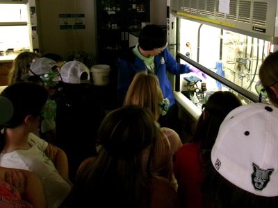 A graduate student demonstrates a reaction to a group of students,