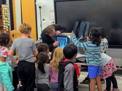 A UM role model walks students through an illuminated X-Ray