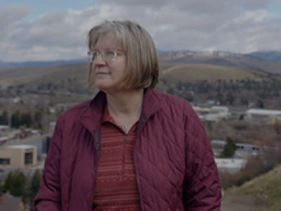Dr. Simona Stan hiking and looking out towards the Missoula Valley.