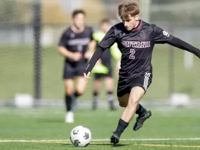 Griz Men's Soccer player kicking ball
