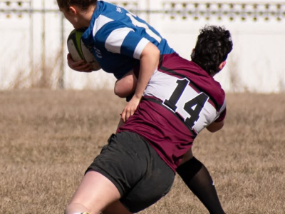 Griz Women's Rugby Player Making a Tackle