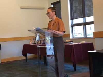 Graduating Senior, Abigail H., reads a piece during the capstone project readings in the Davidson Honors College
