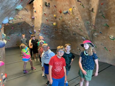 Children on a tour of a climbing gym