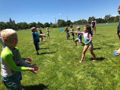 Children playing and throwing water ballons back and forth