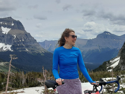 Susan stands behind her bike