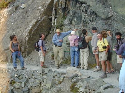Don and a group in front of a rock face